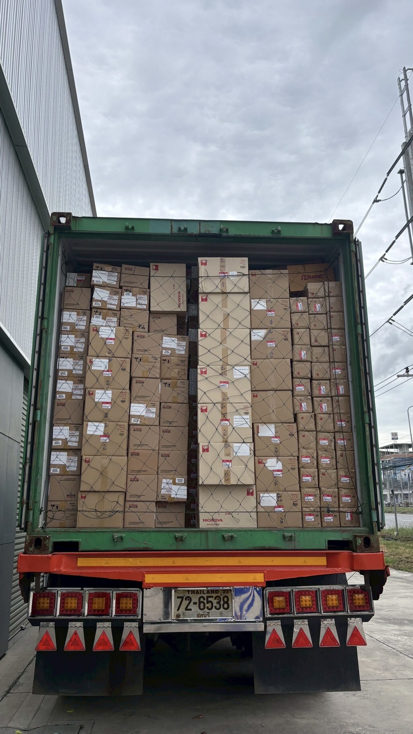 Container loaded with genuine Honda motorcycle parts for international export